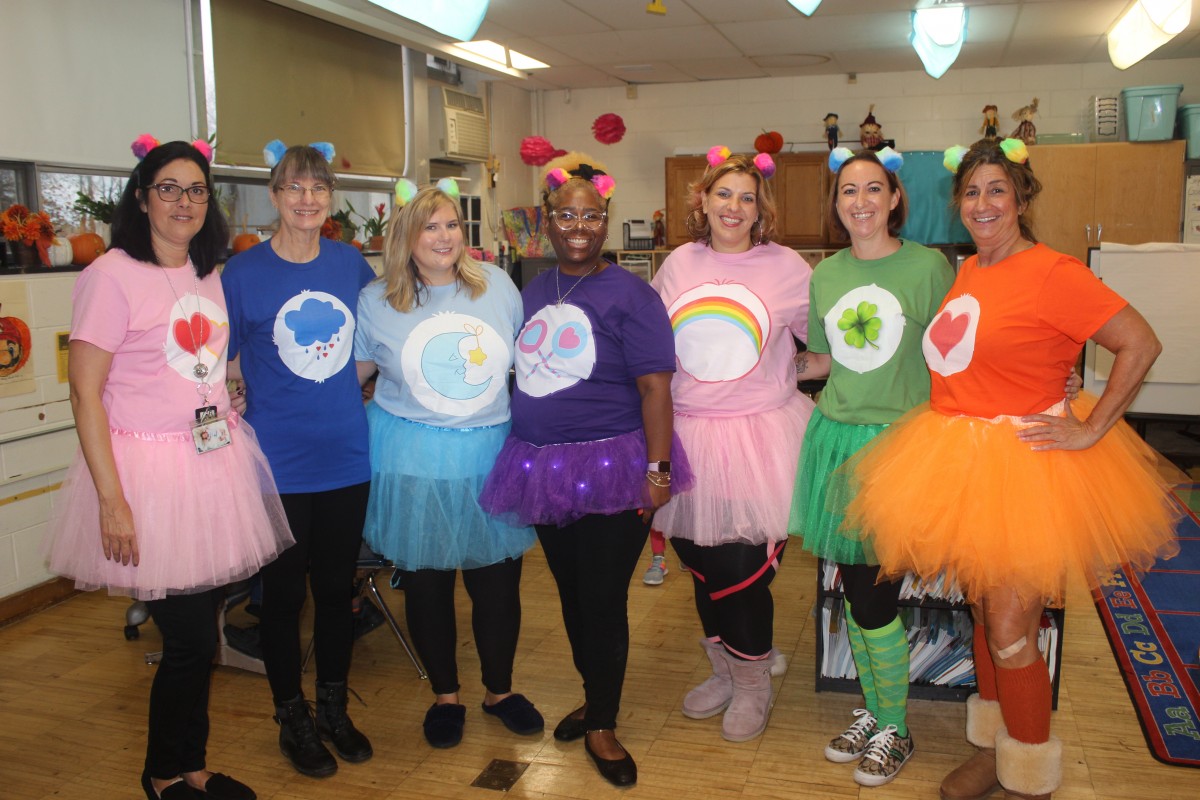 Teachers pose in their Care Bear costumes.
