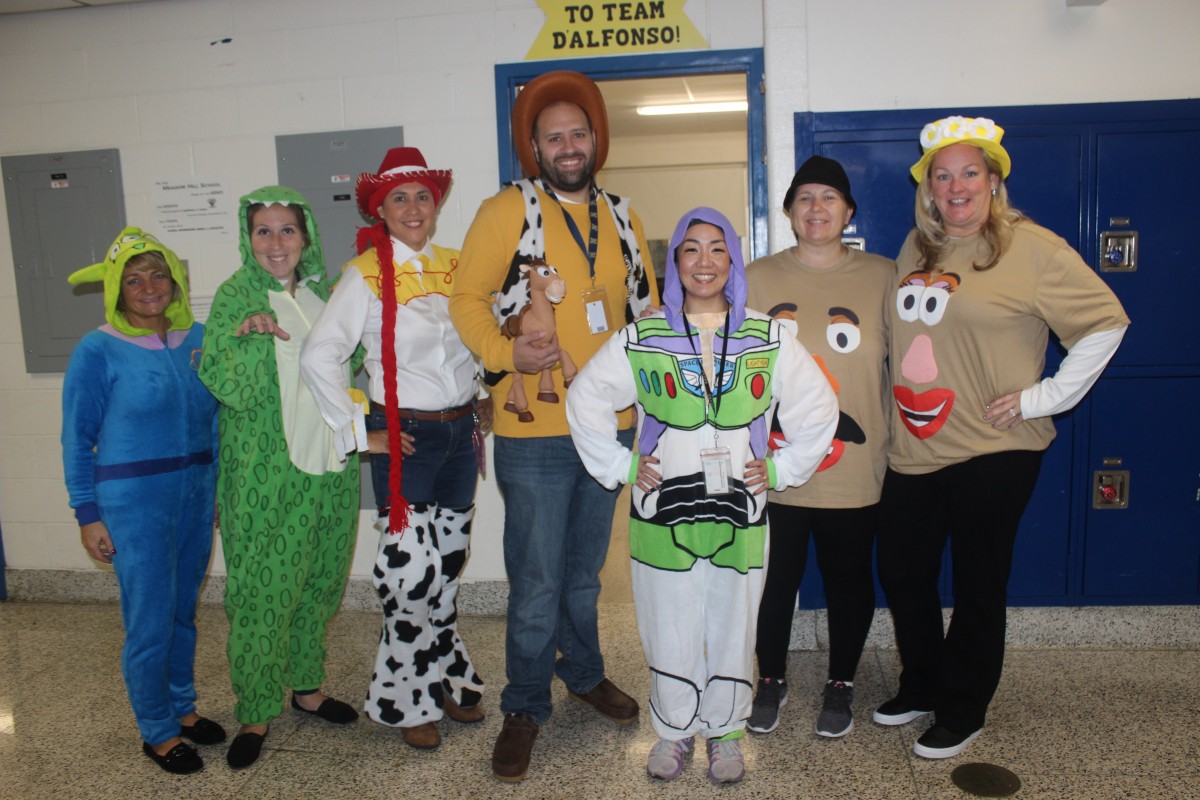 Teachers pose in their Toy Story costumes.