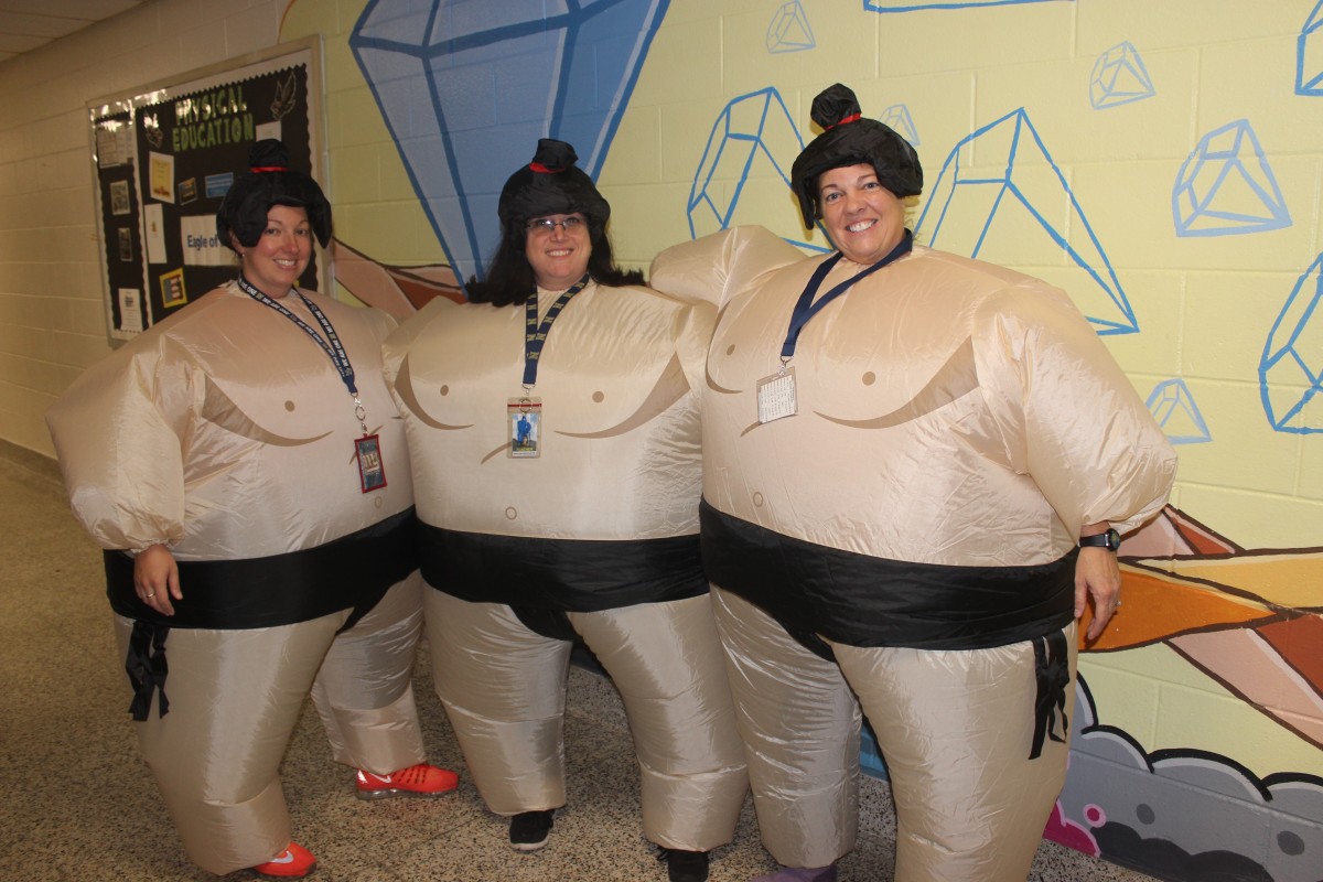 Teachers pose in their Sumo costumes.