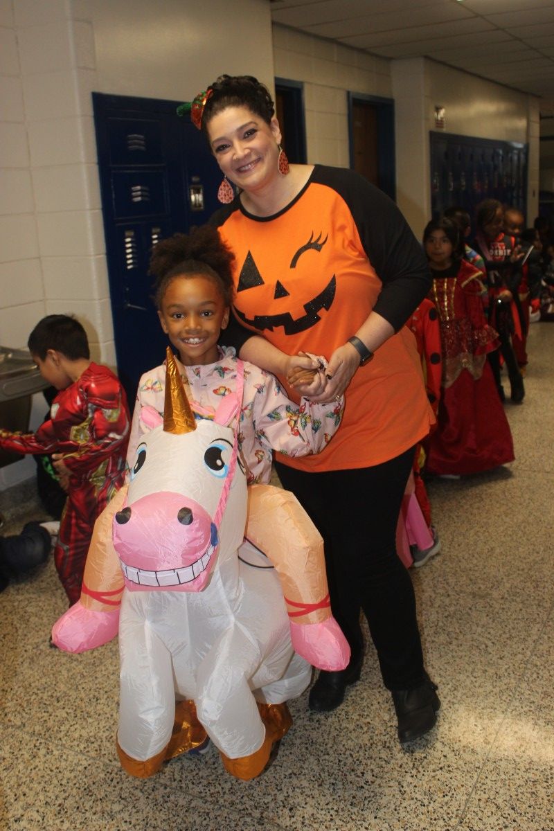 Student and teacher pose in their costumes.