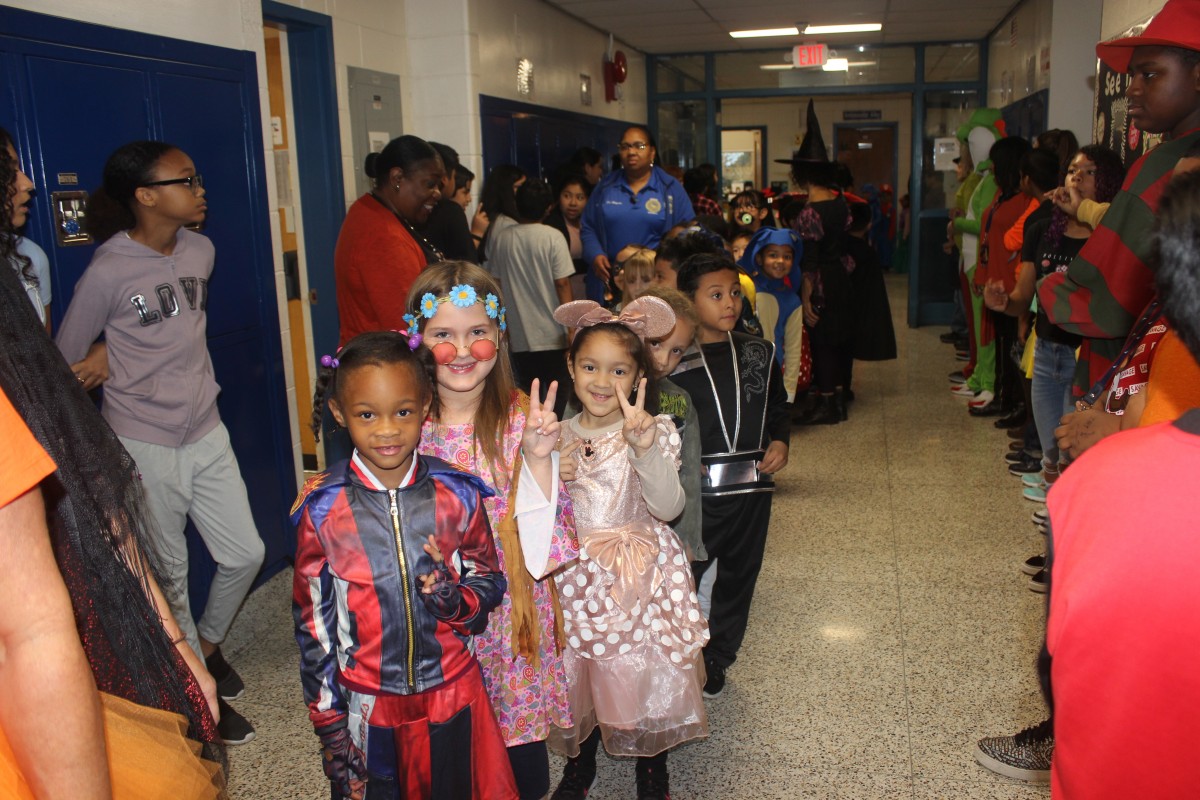 Students participate in hallway Halloween parade.