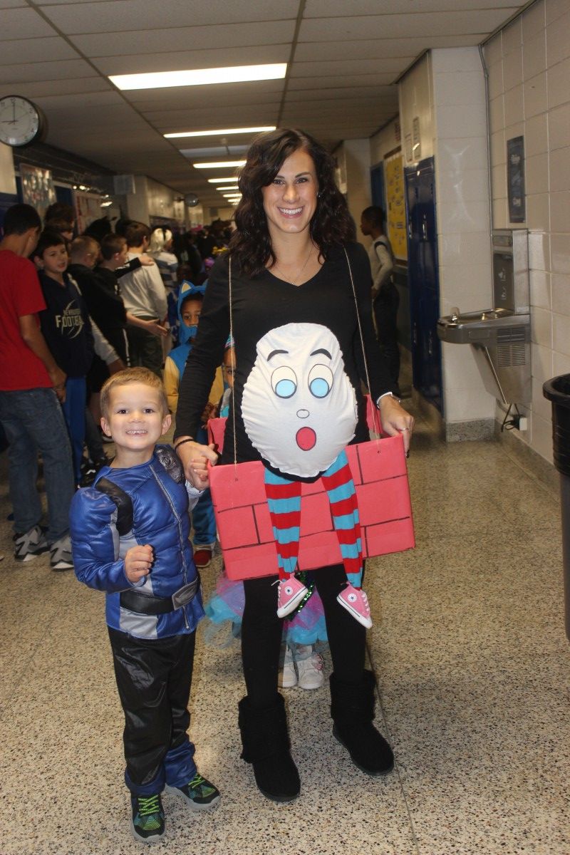 Student and teacher pose in their costumes.