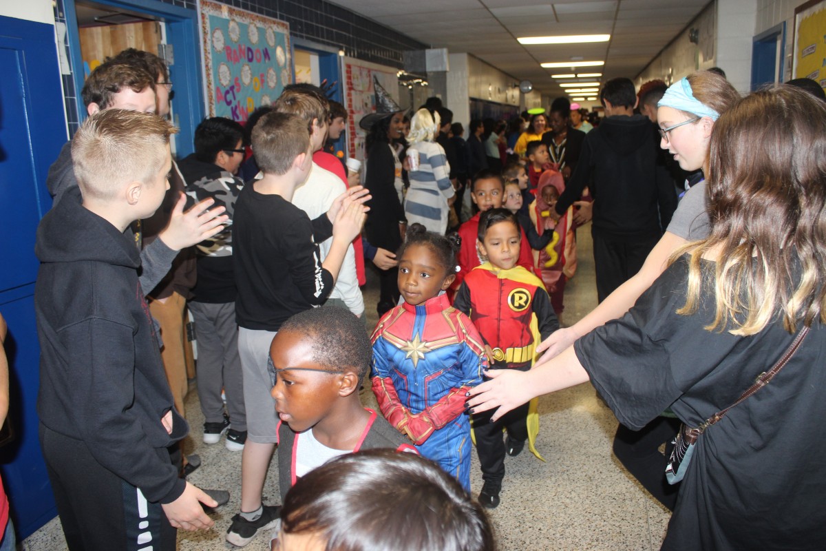 Students participate in hallway Halloween parade.