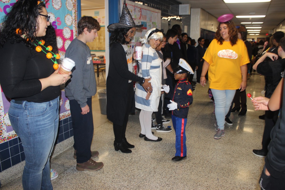 Students participate in hallway Halloween parade.