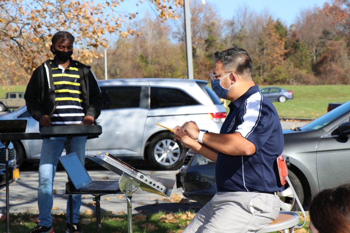 Teacher conducting outside.