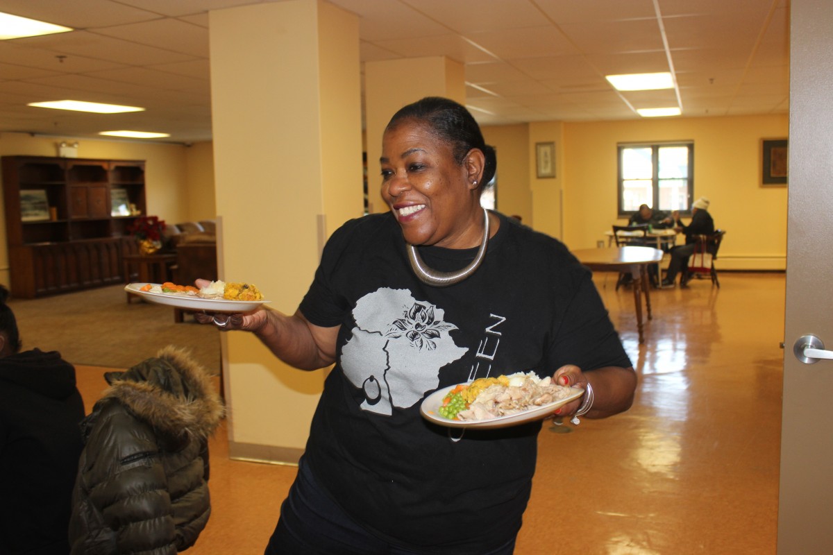 MHS volunteers handing out food and conversing with residents.