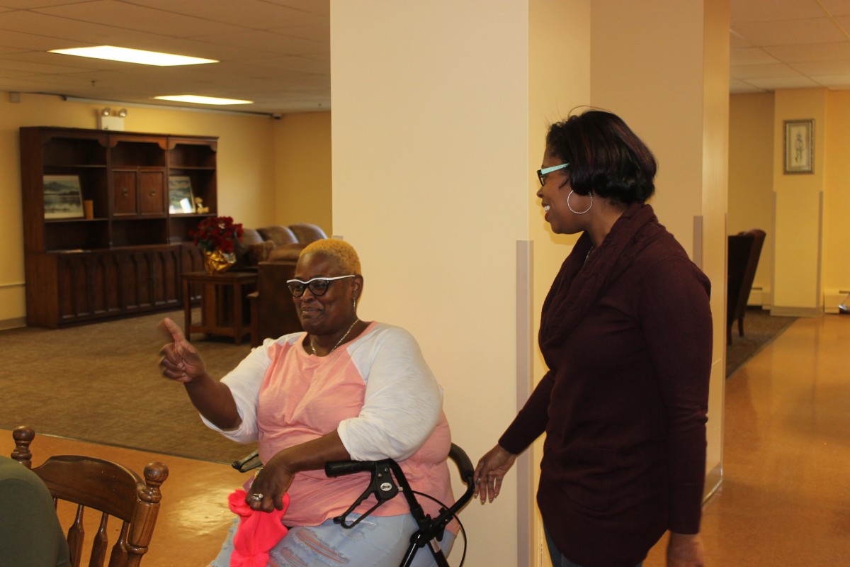 MHS volunteers handing out food and conversing with residents.