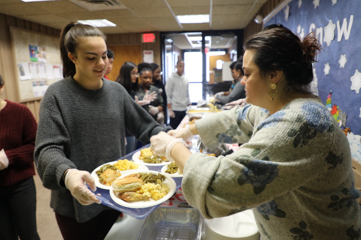 Student serving the guests.