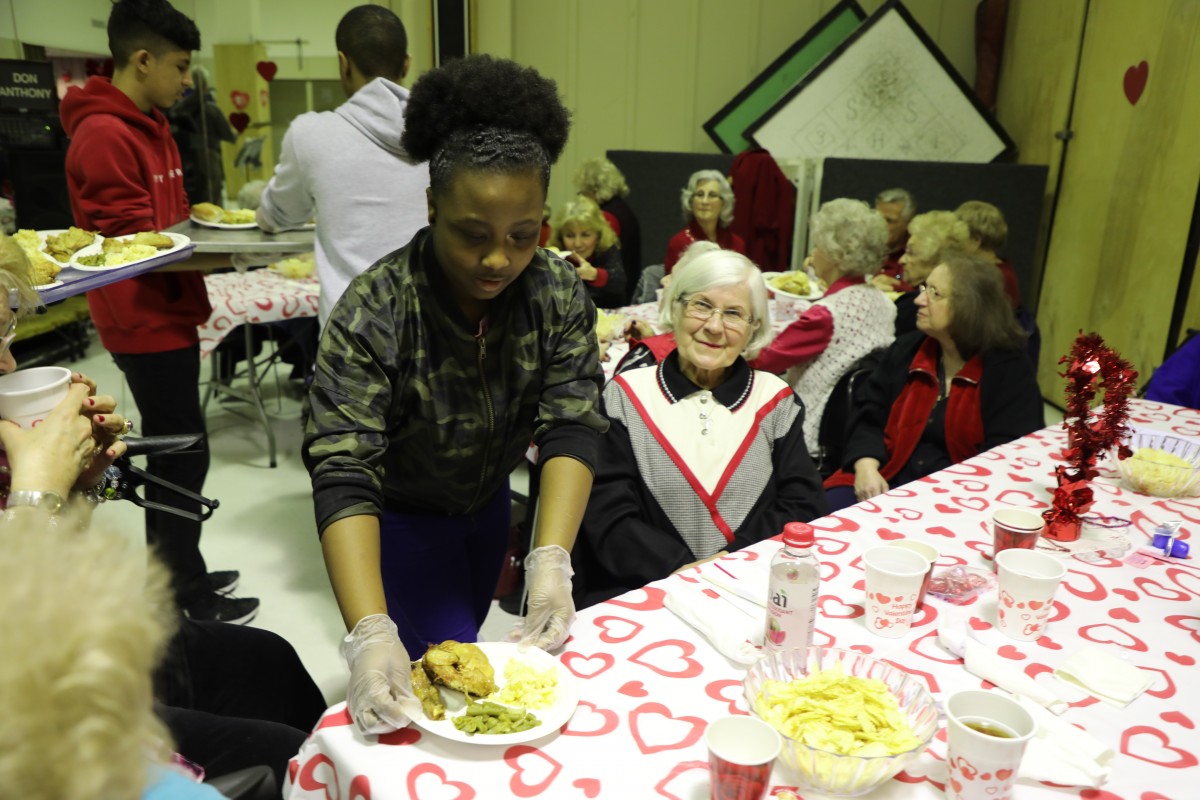 Student serving the guests.