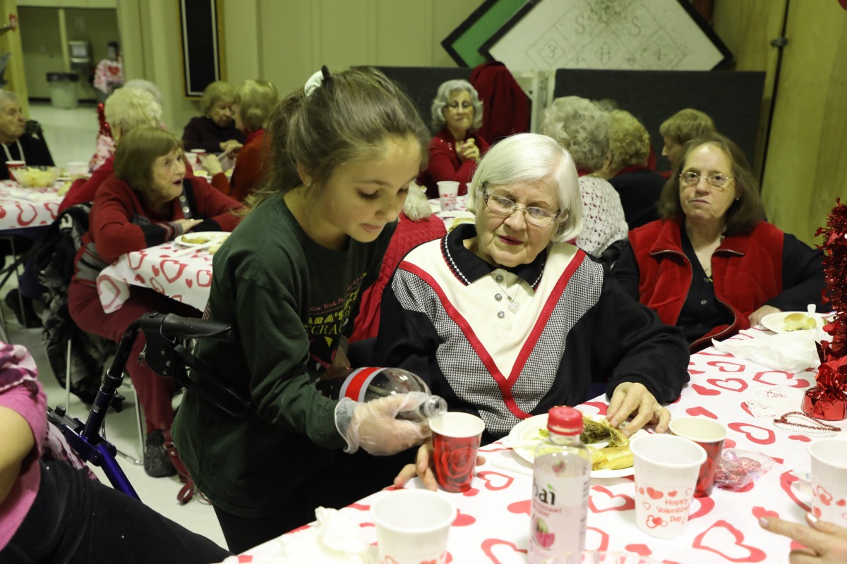 Student serving the guests.