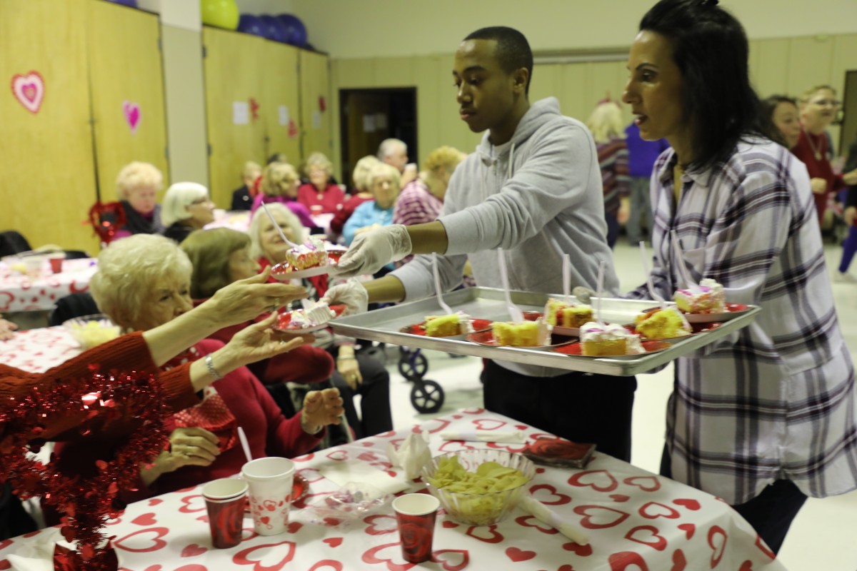 Student serving the guests.