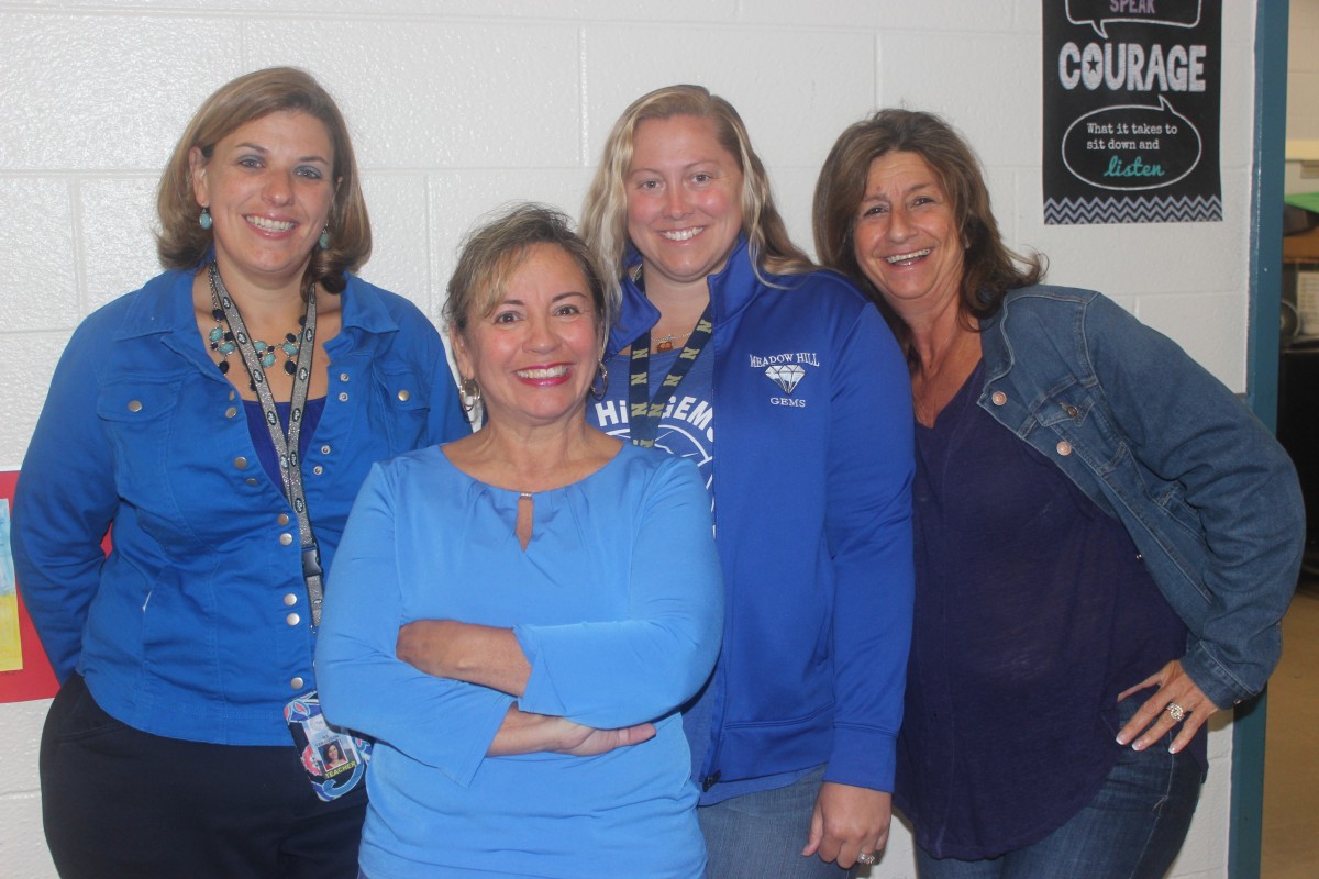 Participants wearing blue pose for a photo.