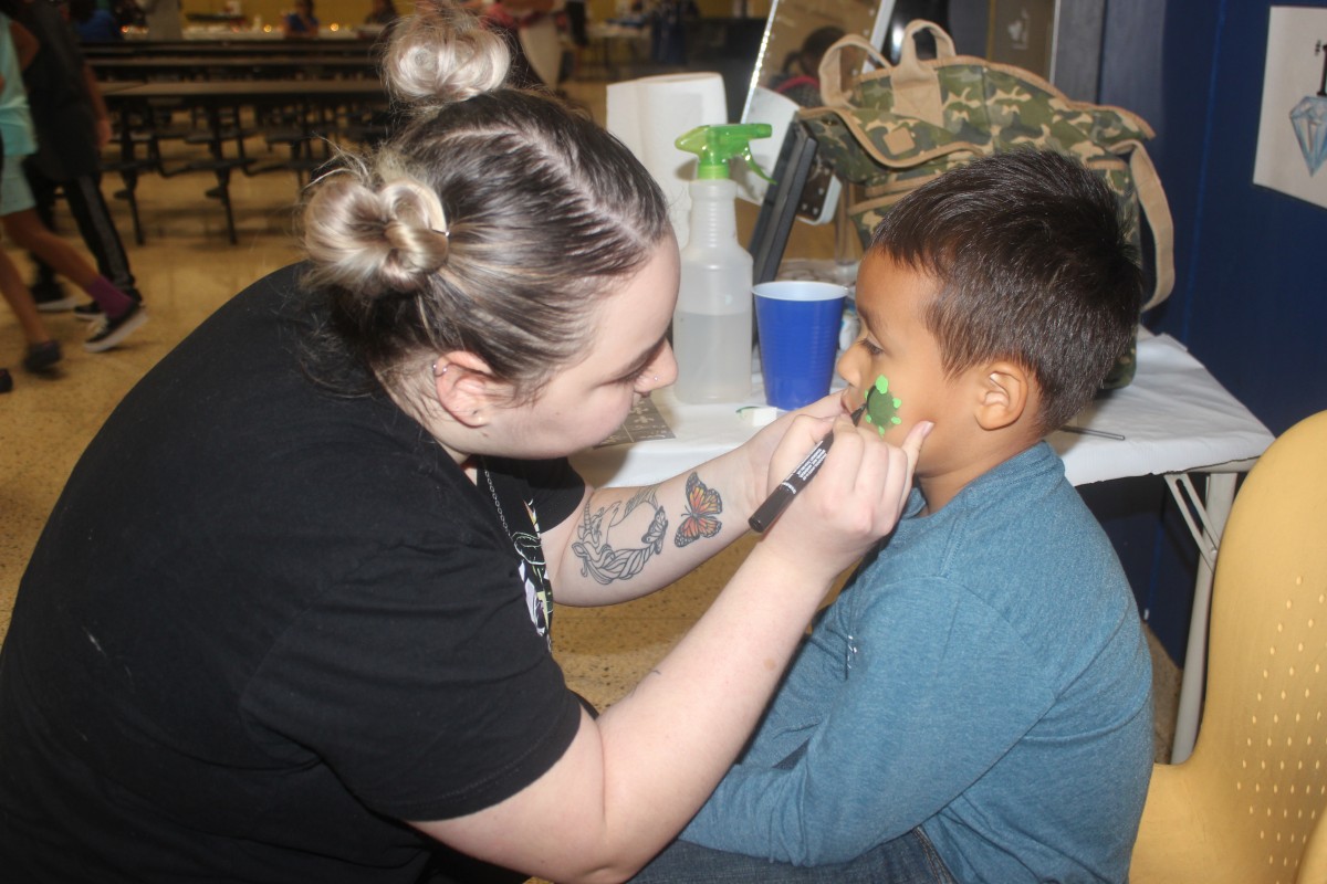 Student getting his face painted.