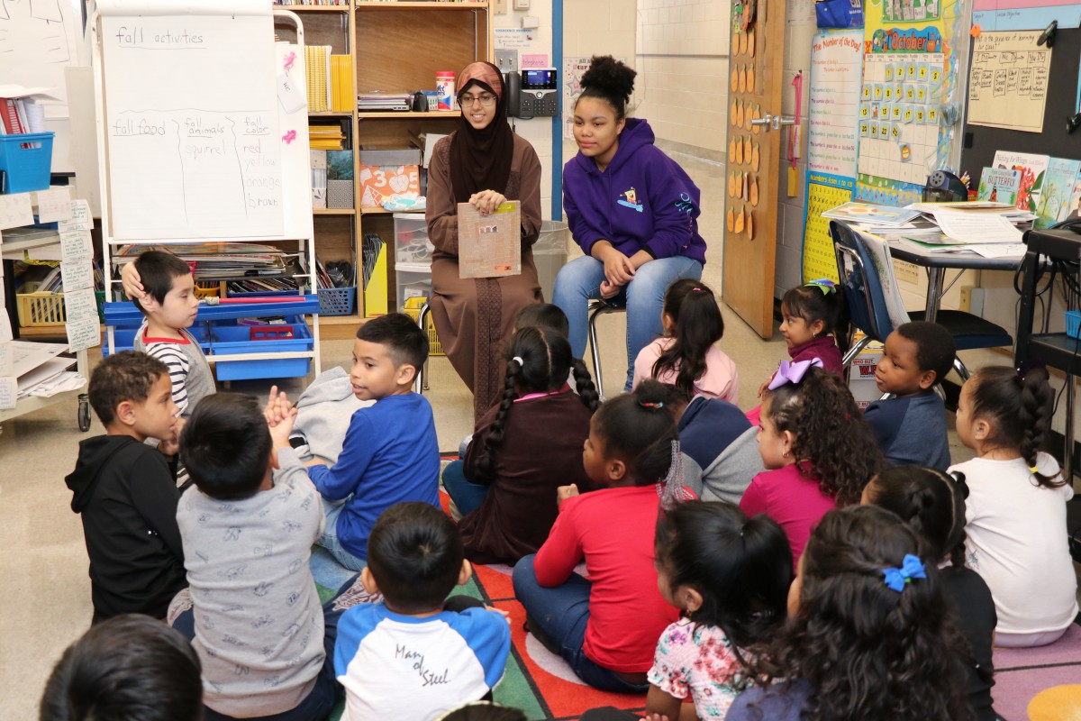 High school scholars ask students questions.