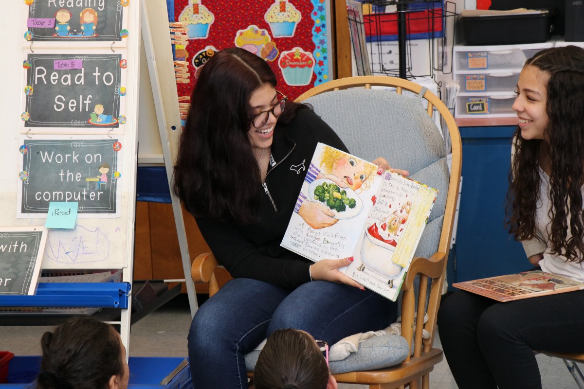 High school scholar reading a book.