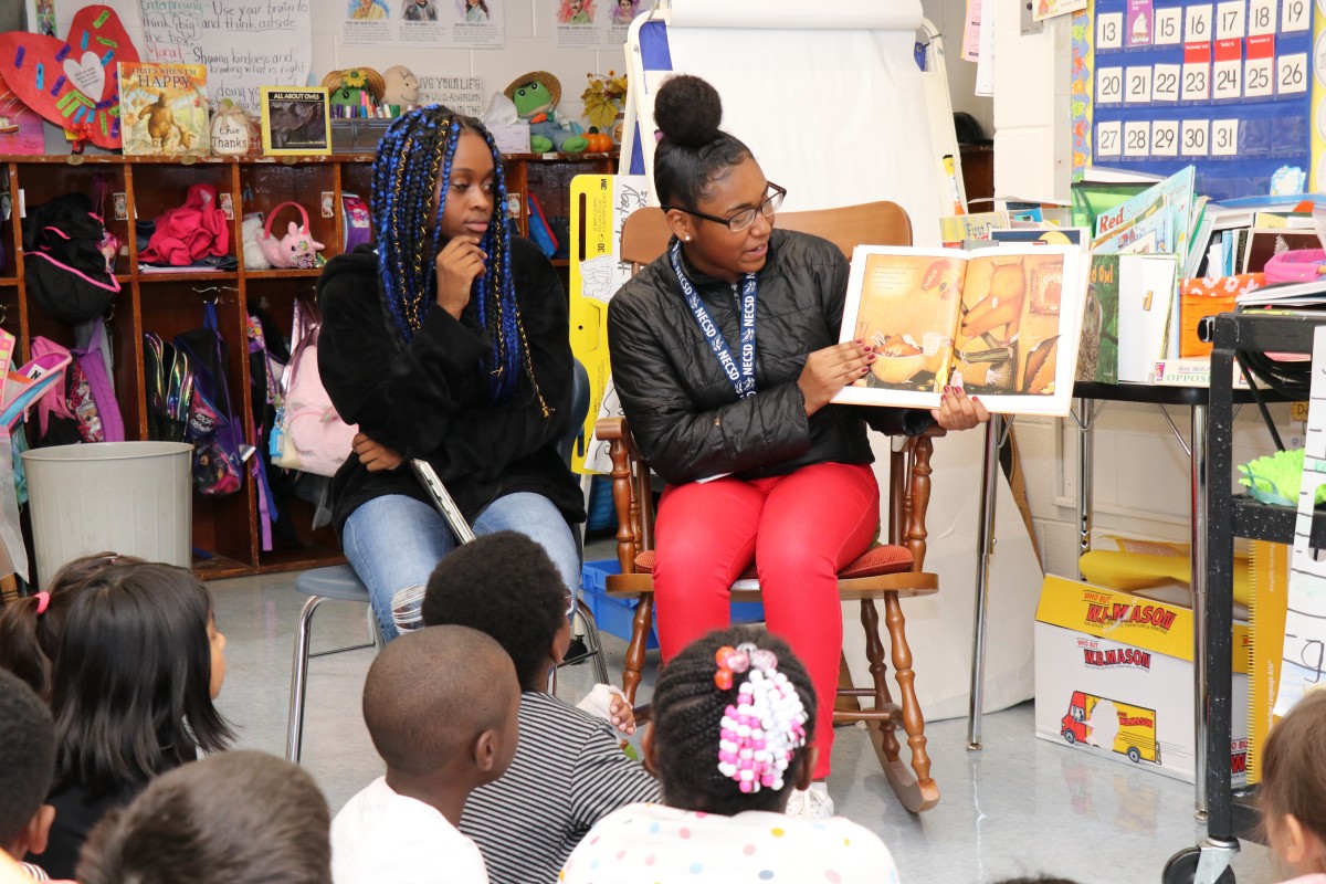 High school scholars ask students questions.