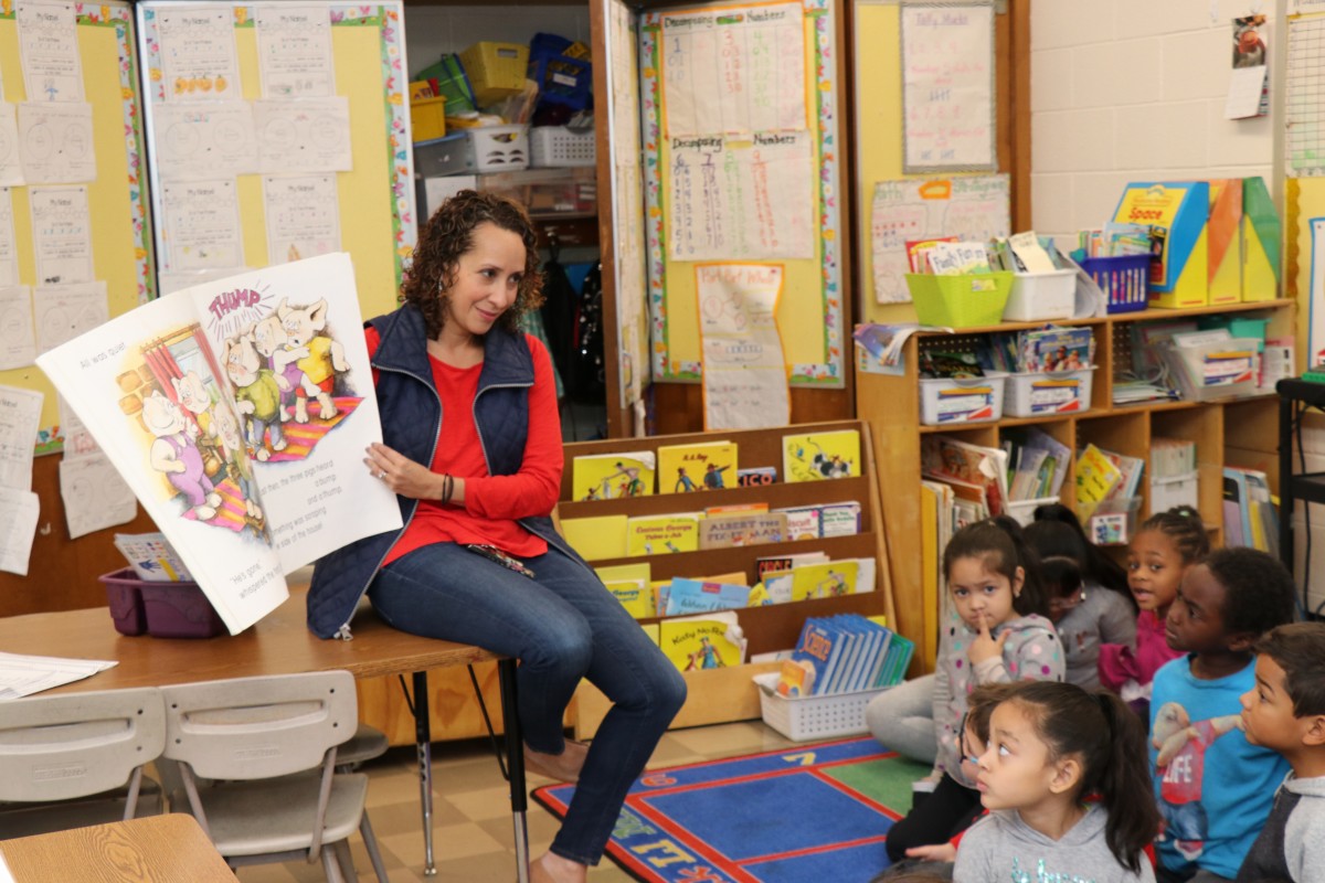 Teacher reading to her students.