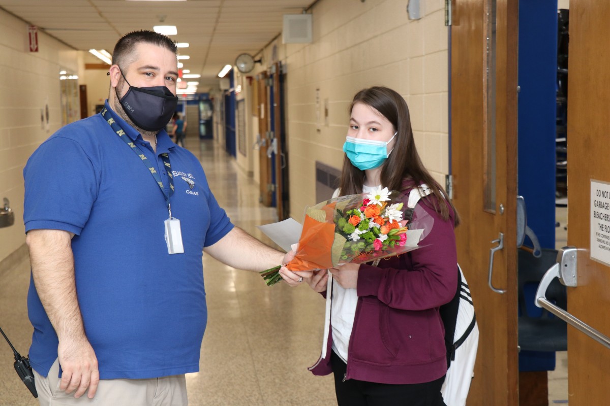 Student poses for a photo with Mr. Prokosch, building principal.