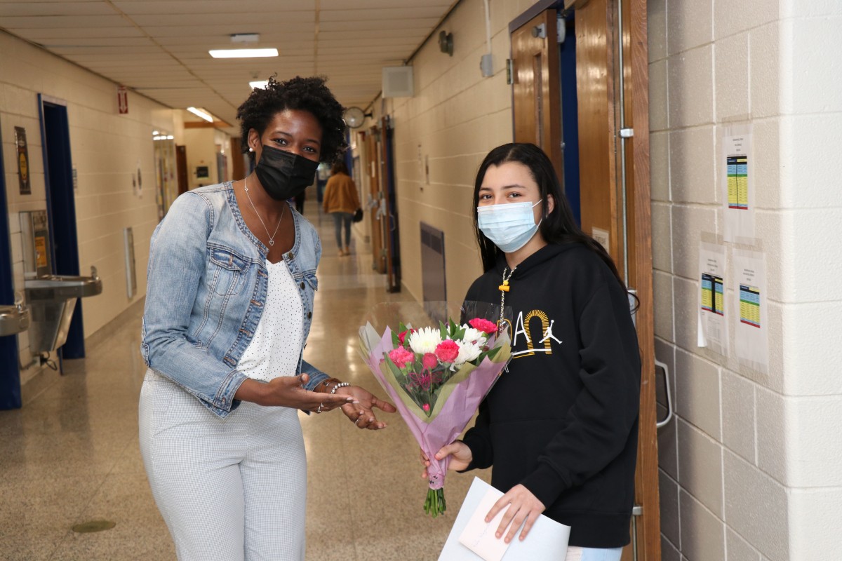 Student poses for a photo with Ms. Cacho, building assistant principal.