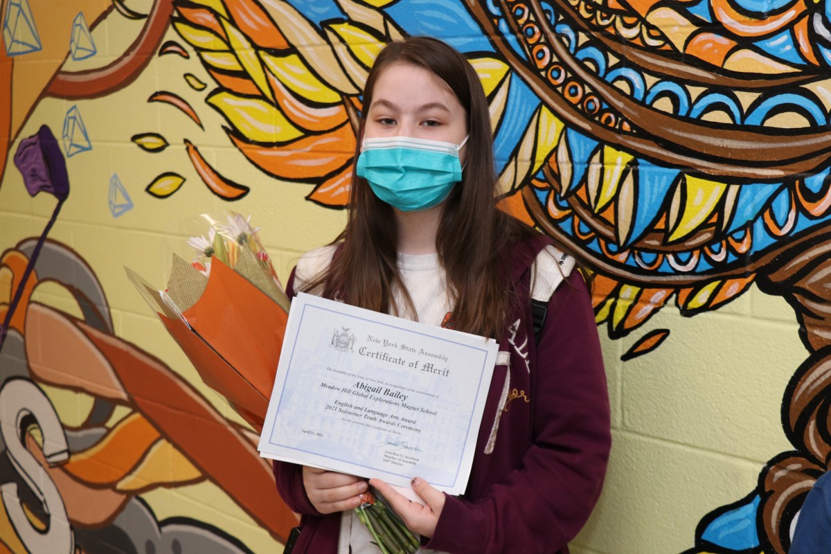 Student holding up certificate.