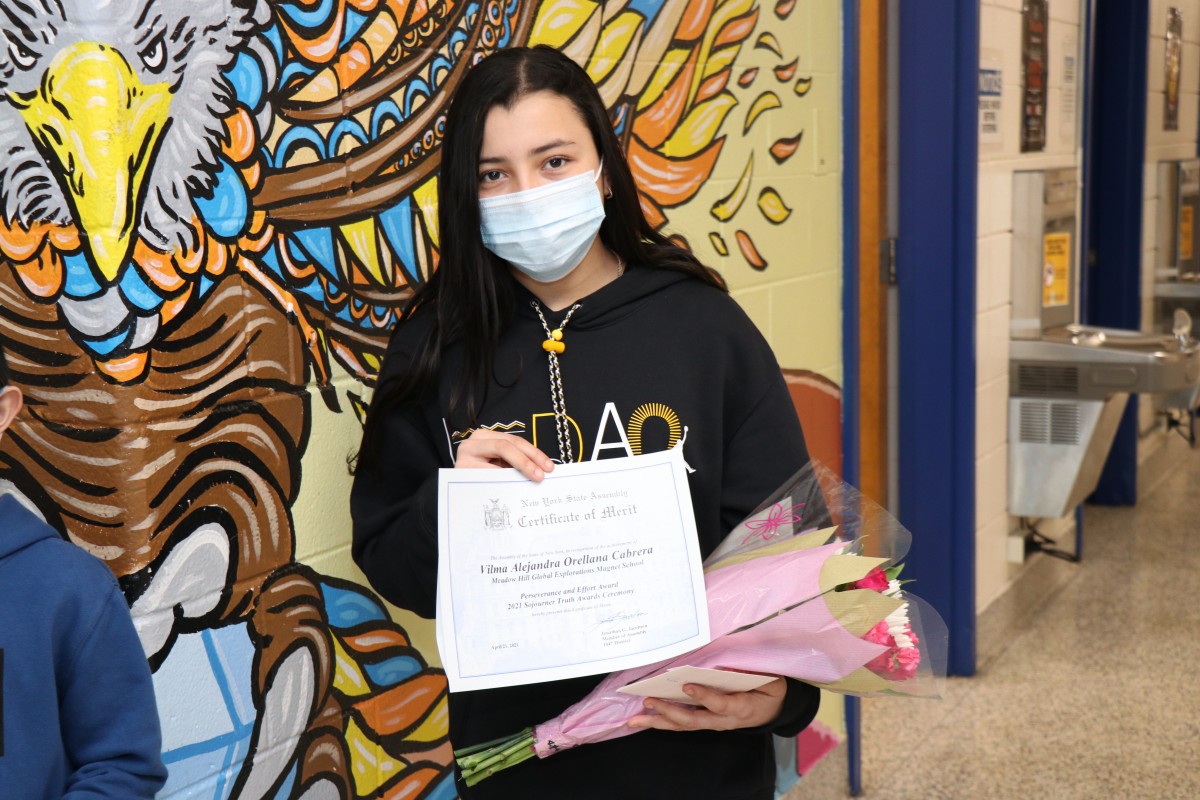 Student holding up certificate.