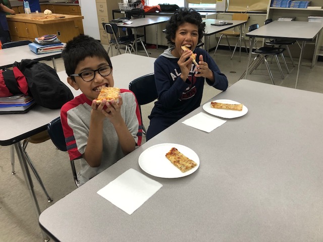 Students enjoying their pizza.