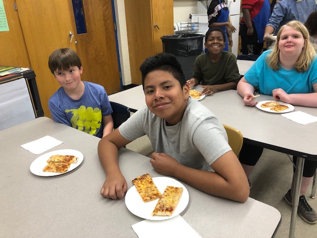 Students enjoying their pizza.