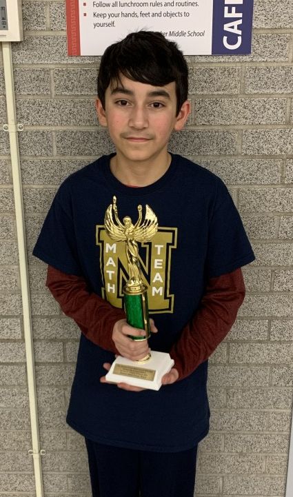 Anakin Lanolfa from Heritage Middle School won an individual award for highest percentage correct (85%) in Section A. He poses for a photo with his trophy.