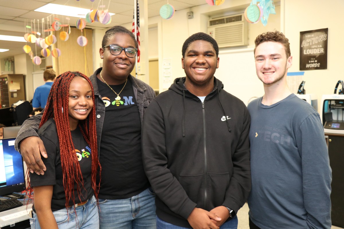 High school scholars pose for a photo.