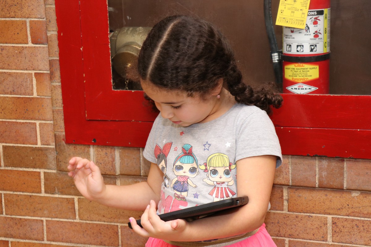 Younger student works on coding project.