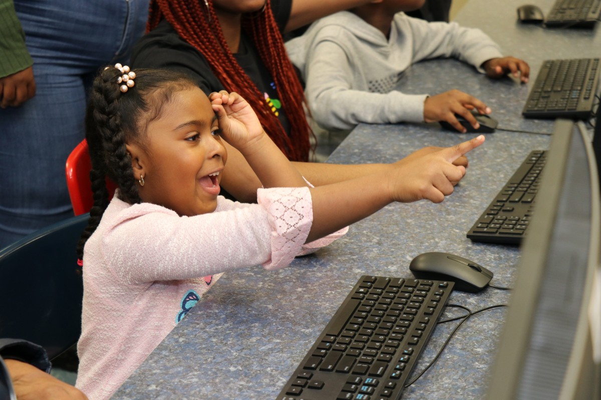 Younger student works on coding project.