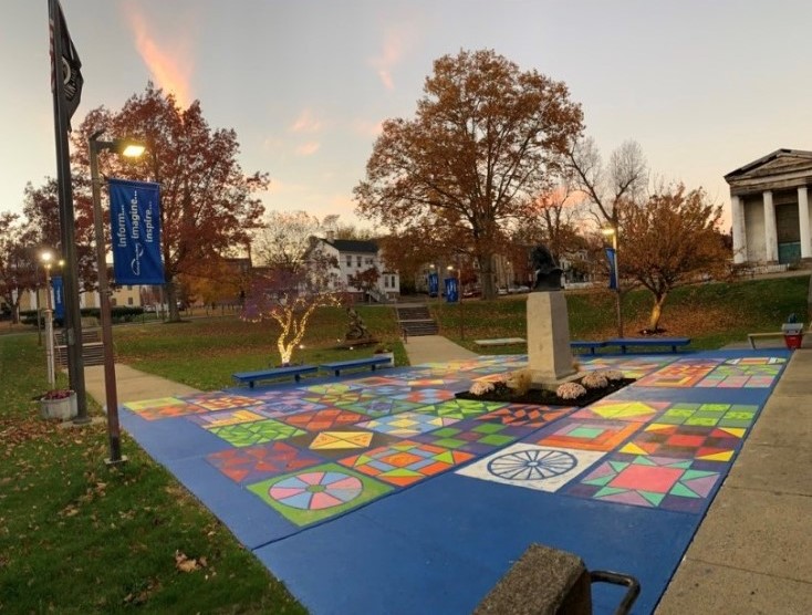 Photo of the statue with the painted Freedom Quilt in the foreground.