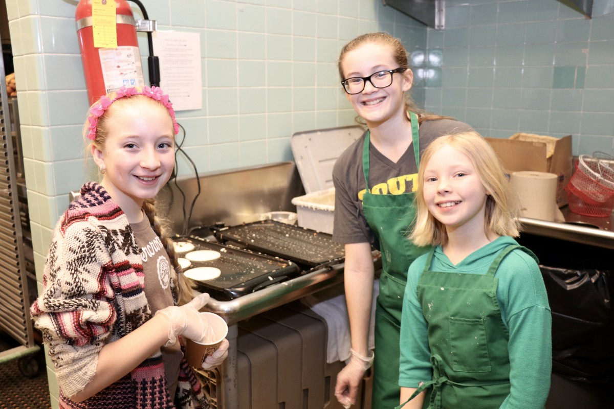 Students pose while preparing school