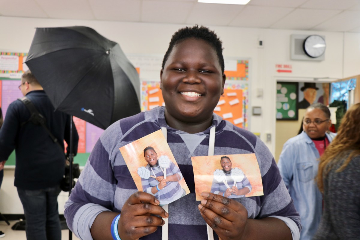 Student holding up picture from photo booth