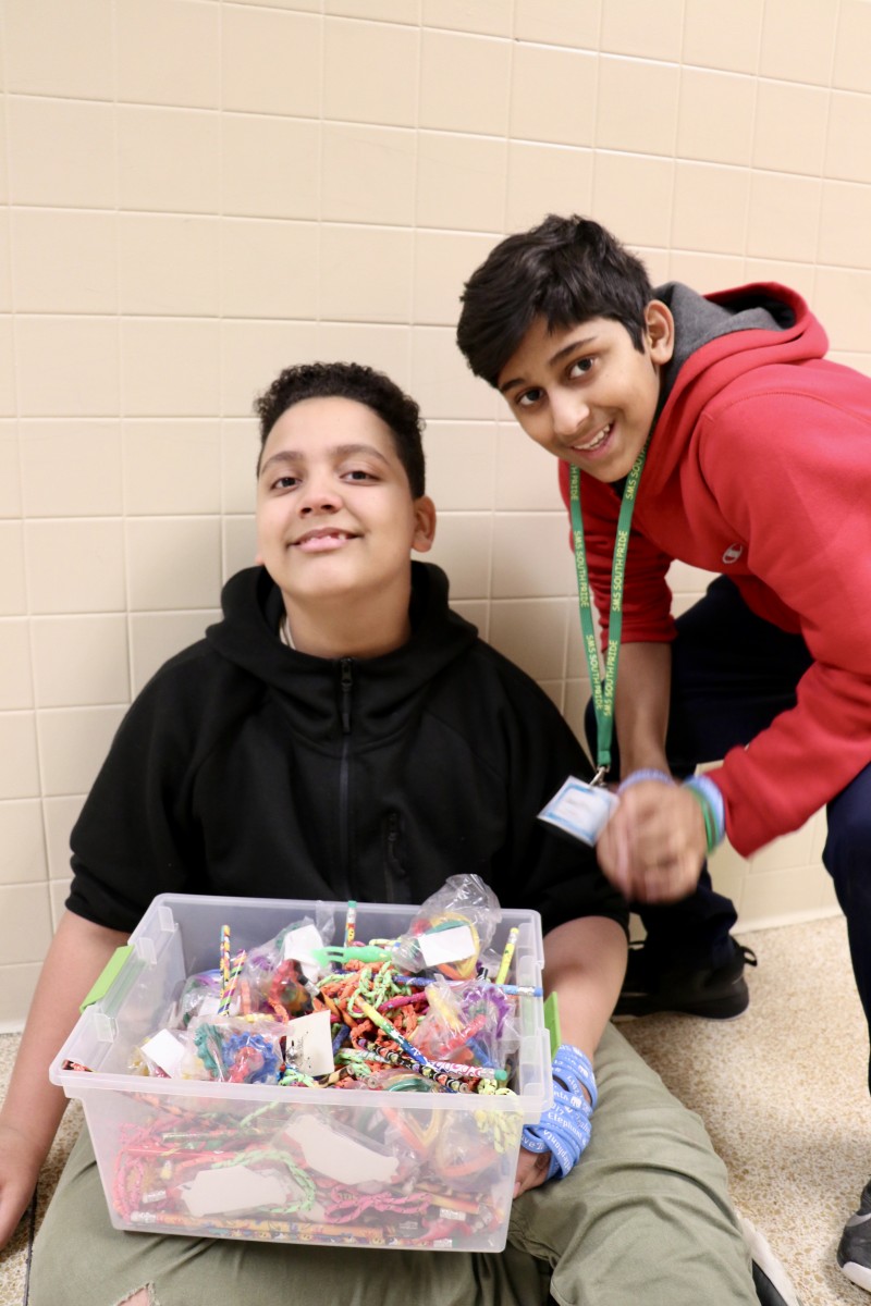 Students pose next to prize box