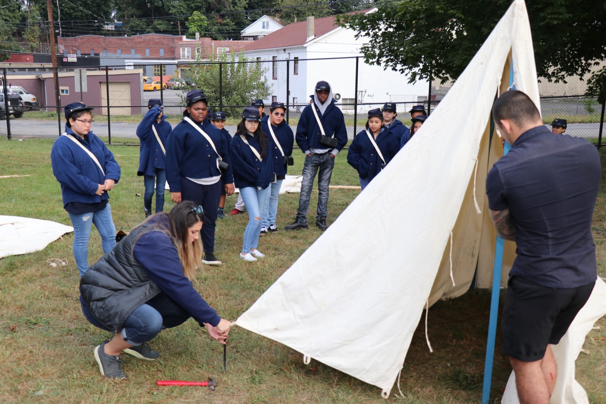 Students learn how to put up a tent.