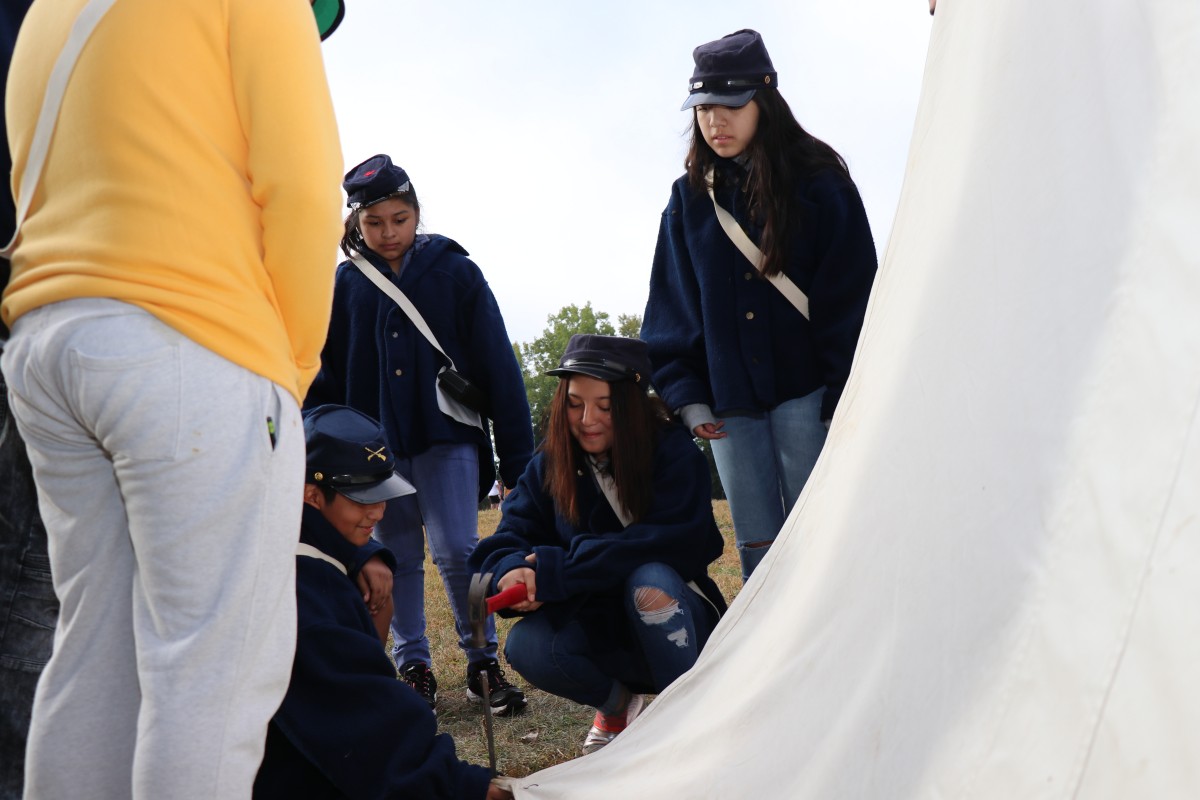 Students learn how to put up a tent.