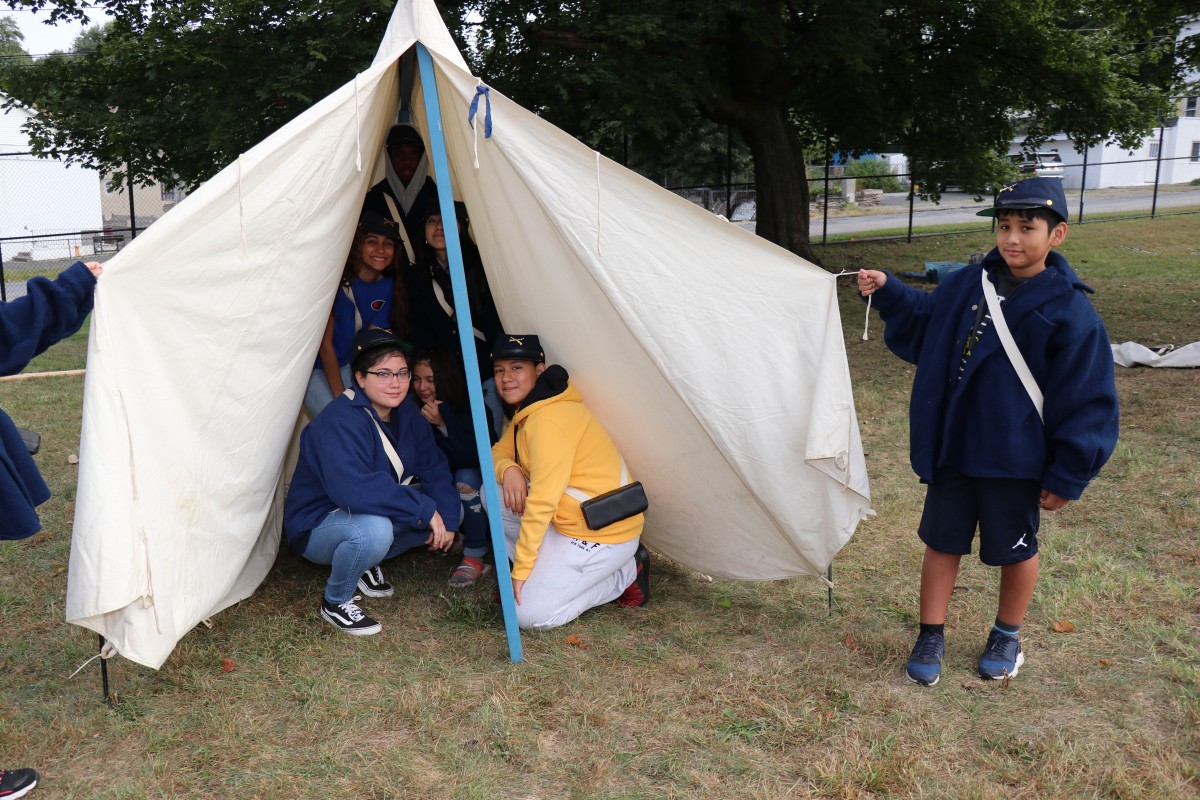 Students pose with the tent they put up.