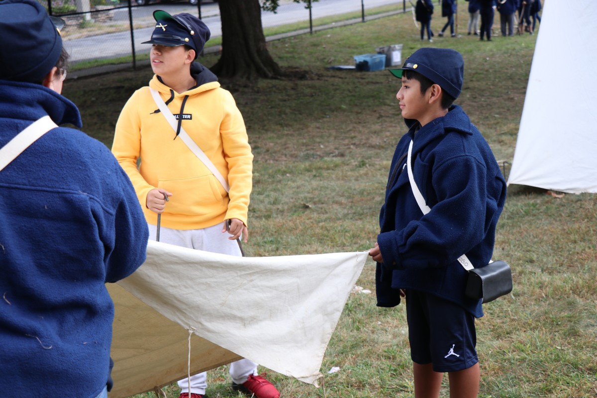 Students learn how to put up a tent.