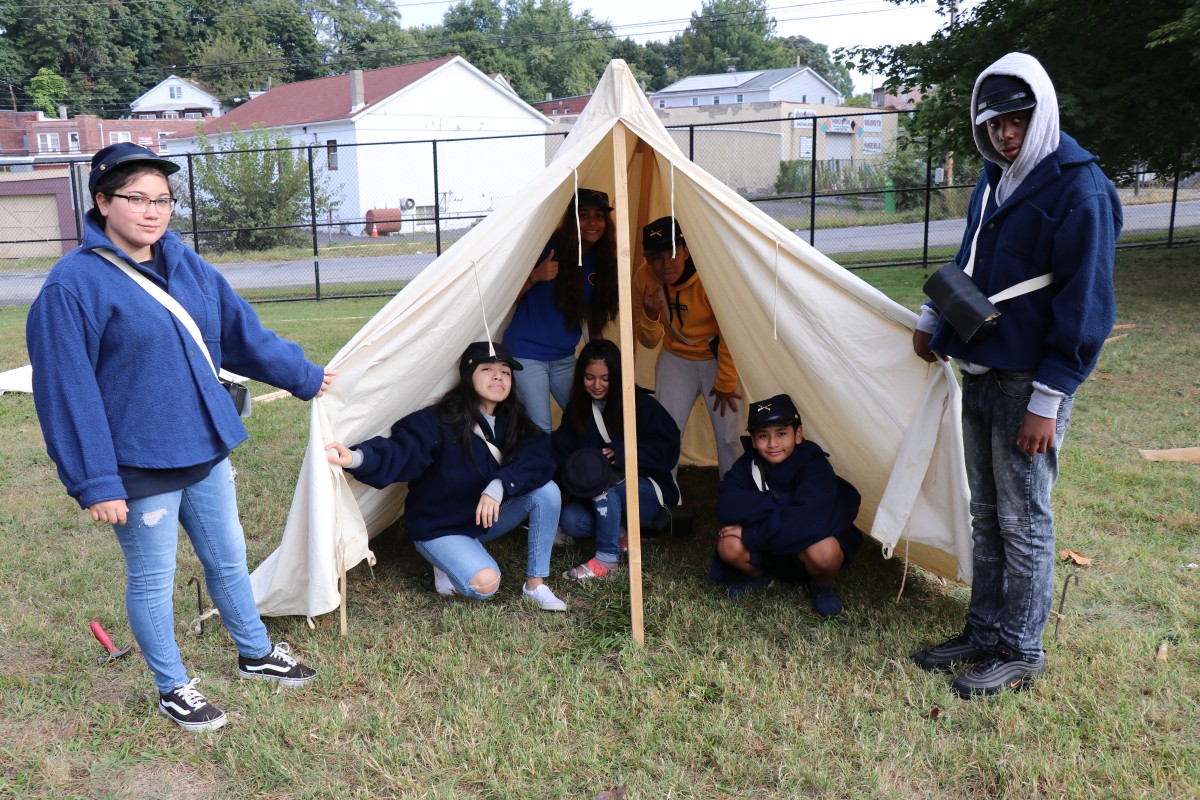Students pose with the tent they put up.