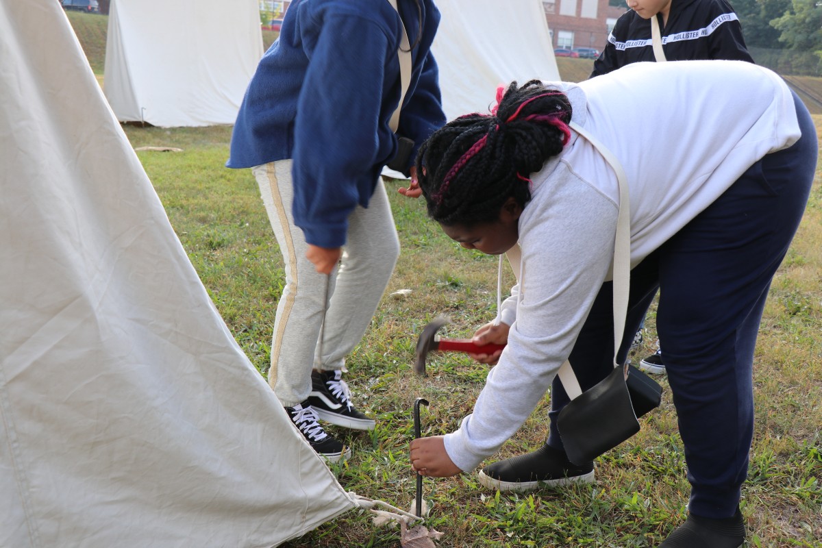 Students learn how to put up a tent.