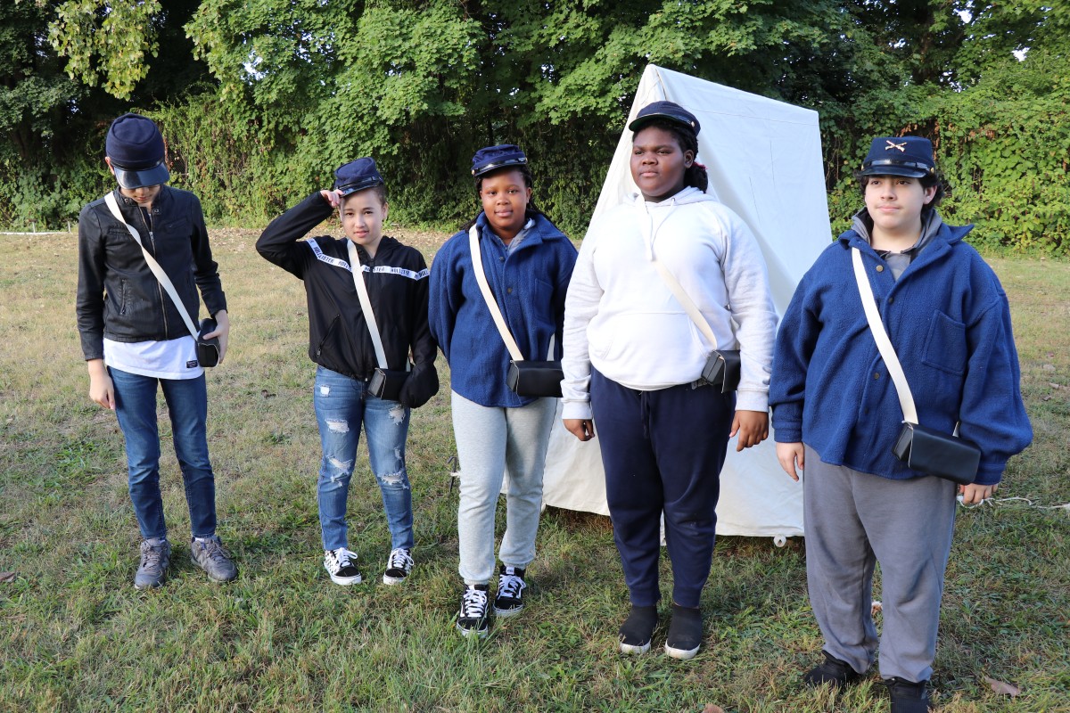 Students pose with the tent they put up.