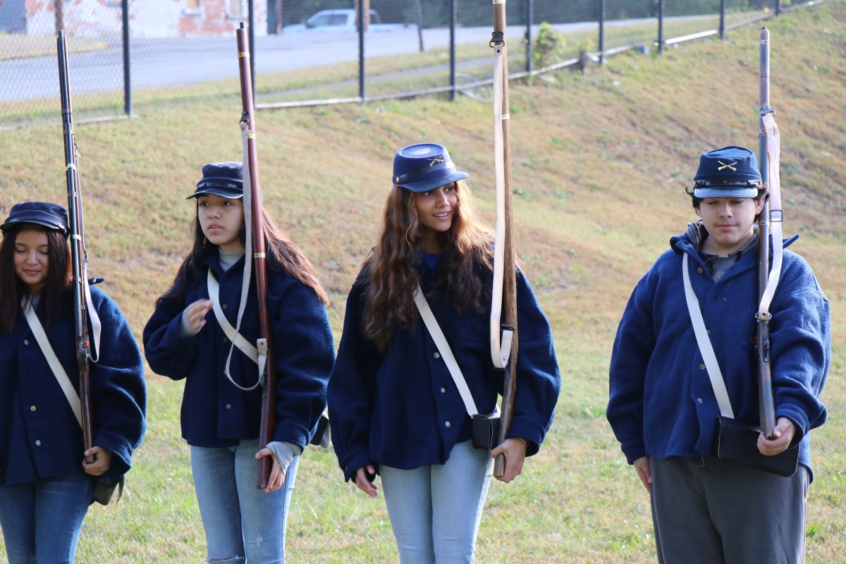 Students stand in line and learn commands.