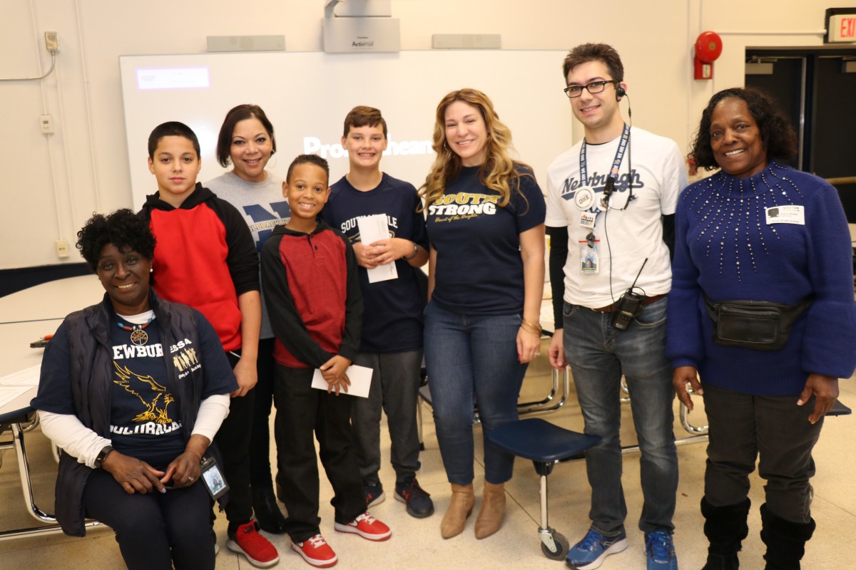 Faculty, staff, and students pose for a photo at the event.