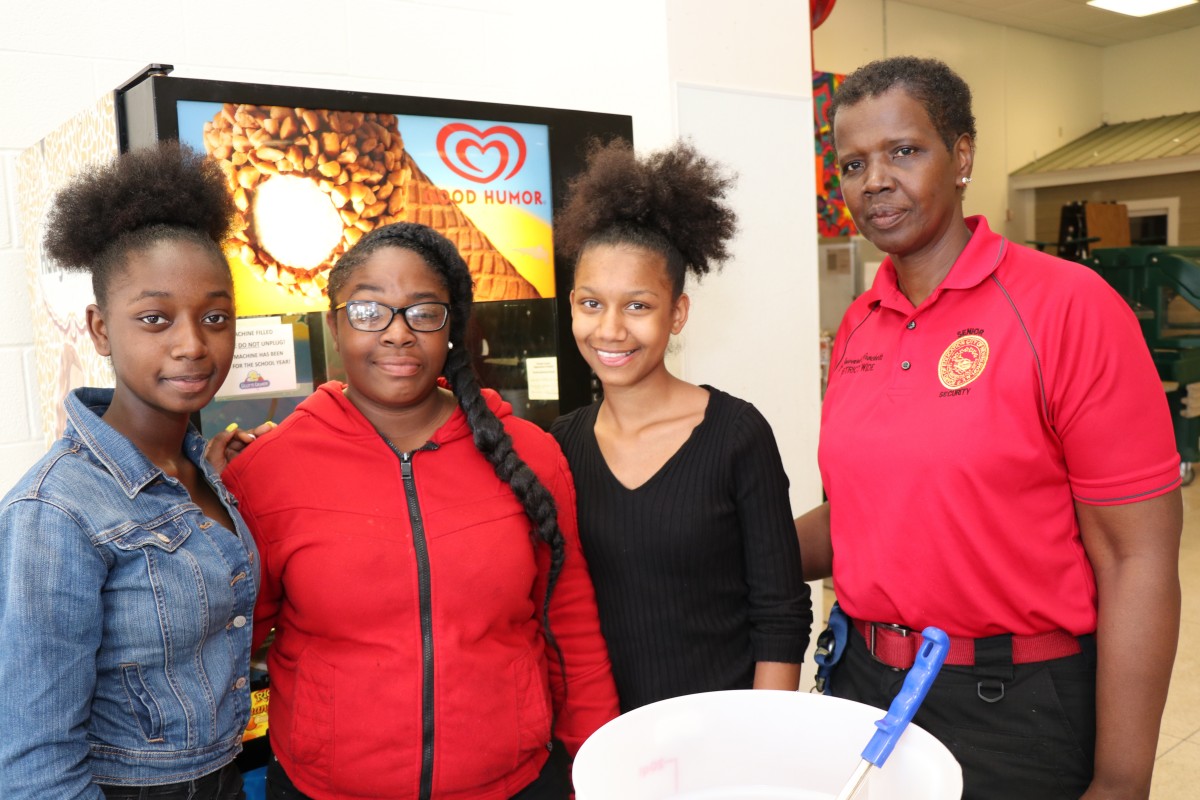 Students stand with Ms. Joyce Howard.