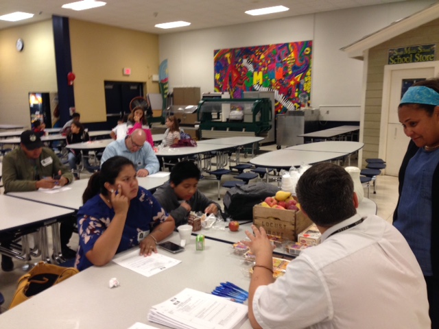 Parents engage in conversation with SMS faculty/staff.