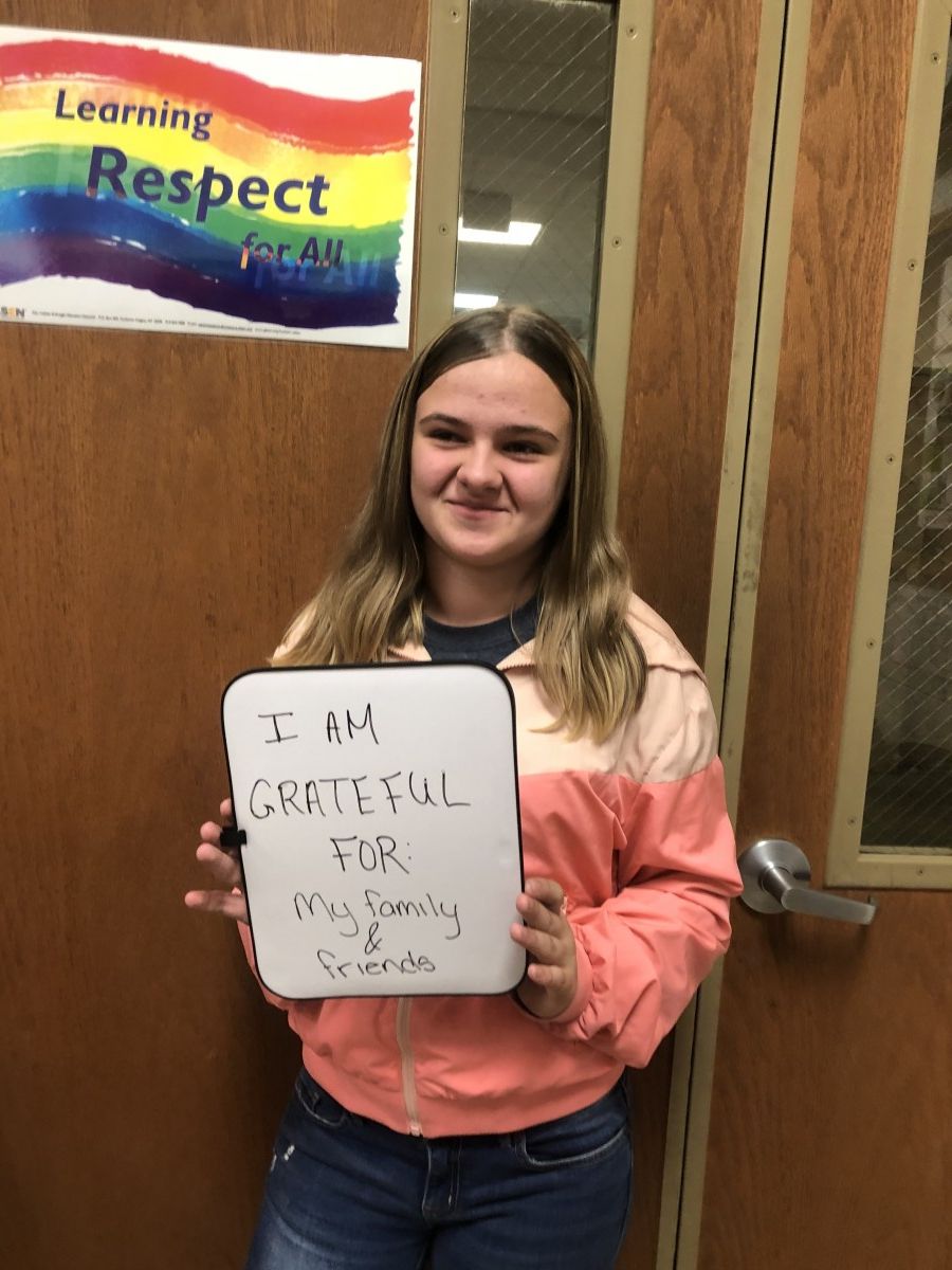 Student holding message of thanks.