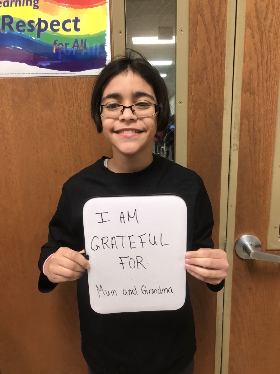 Student holding message of thanks.