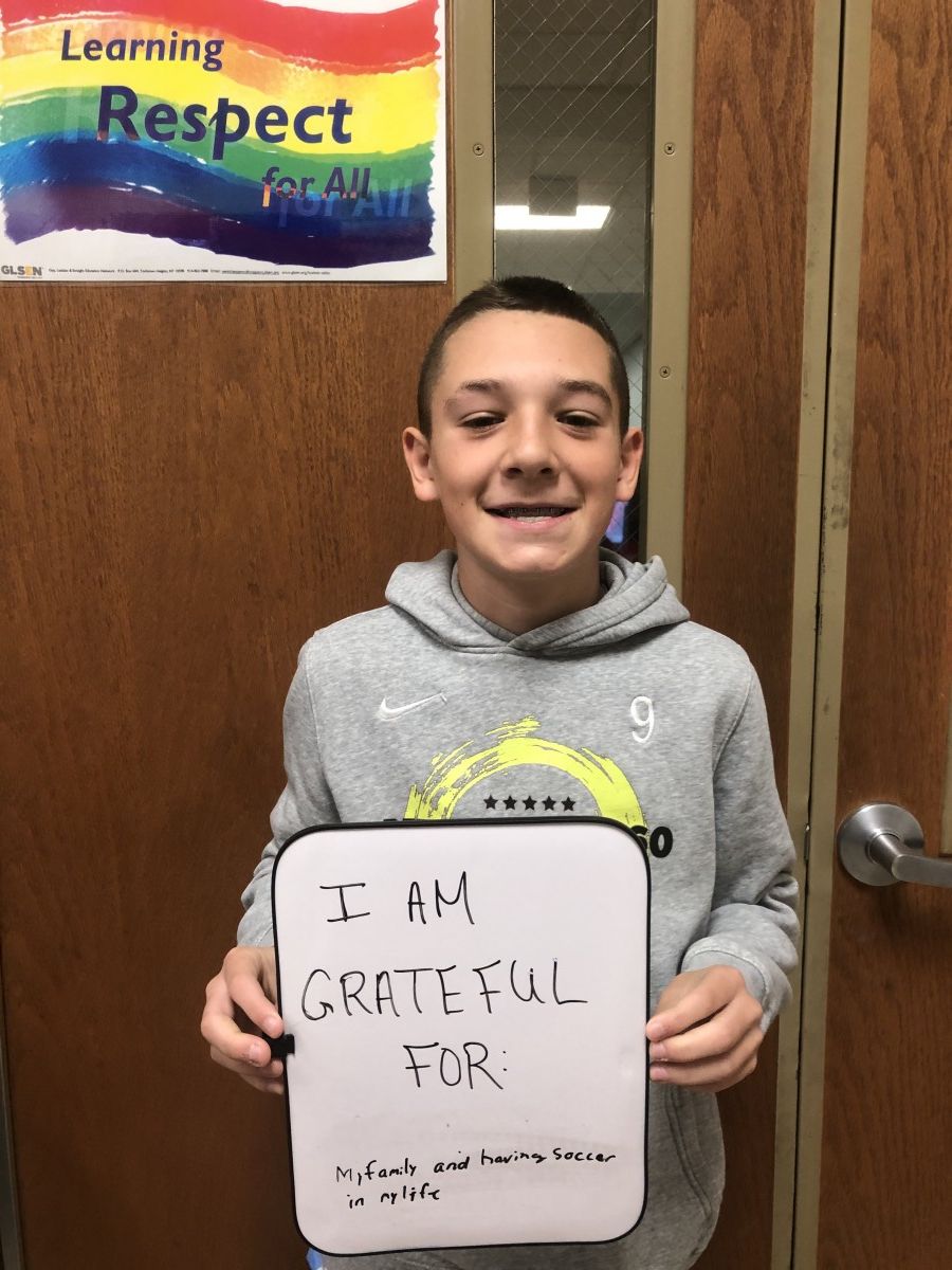 Student holding message of thanks.