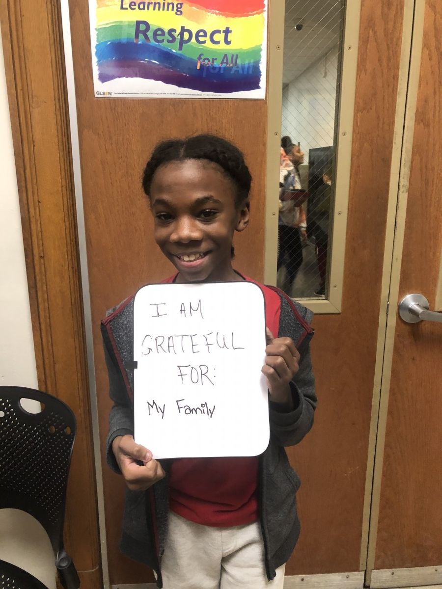 Student holding message of thanks.